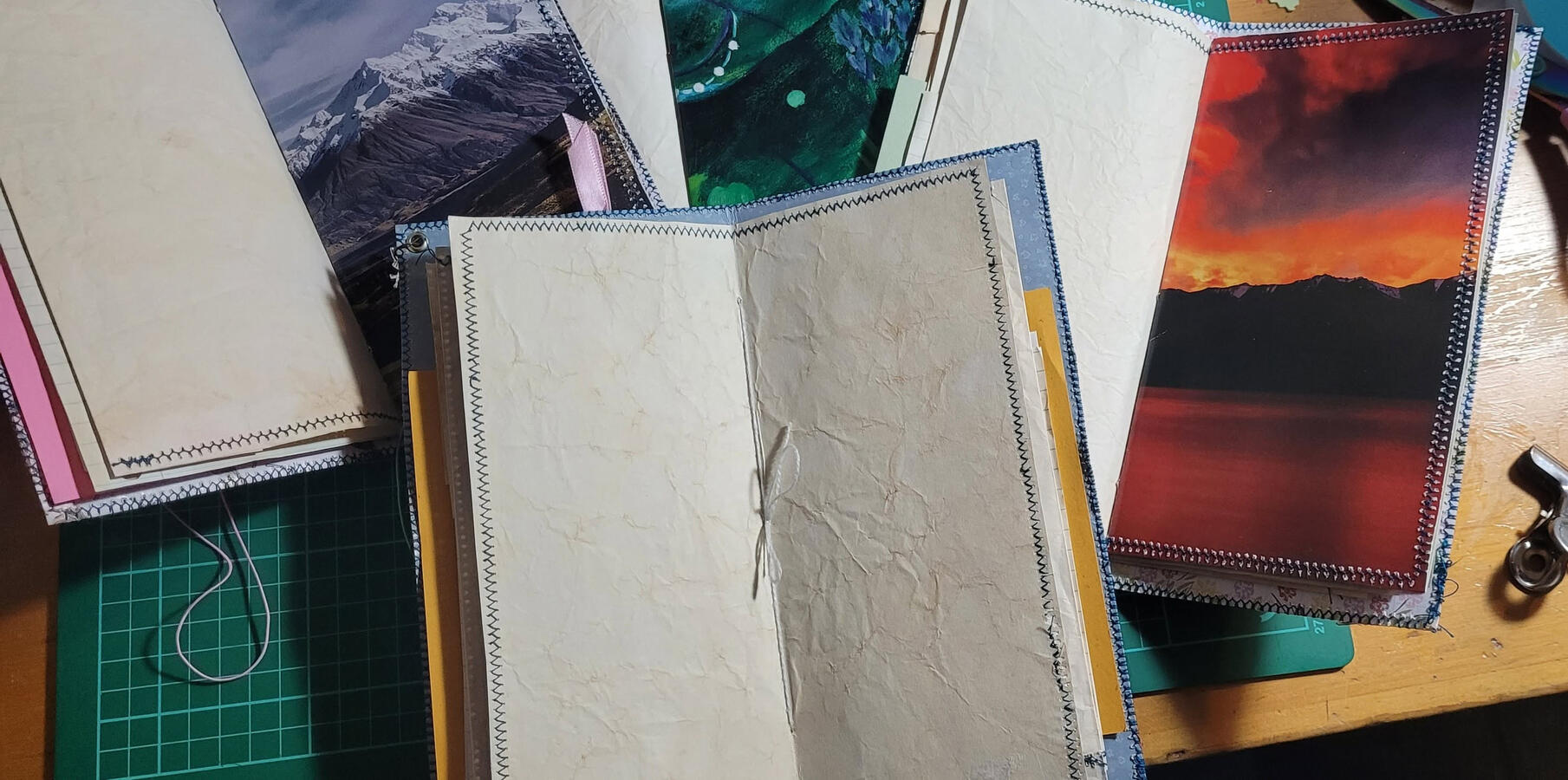 All of these traveller's journals have a full spread of coffee paper in the middle that is backed with a heavier image. All of these traveller's journals have a full spread of coffee paper in the middle that is backed with a heavier image.